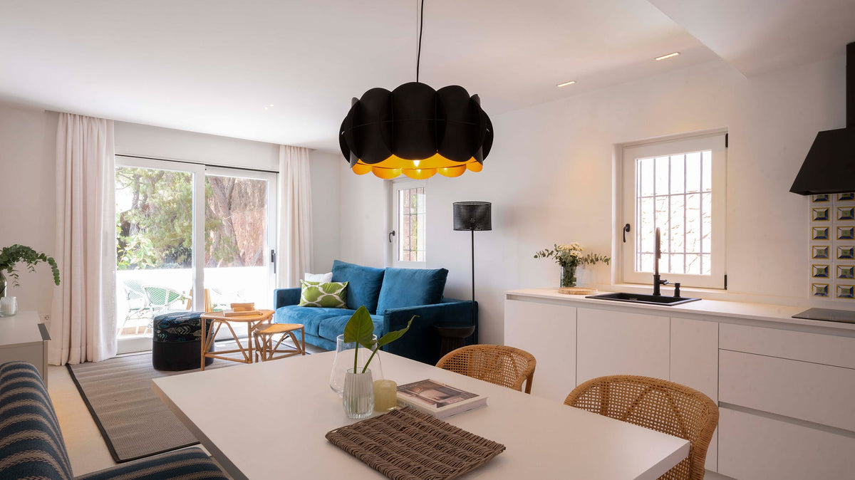 Salón con cocina y comedor de estilo mediterráneo en una casa tradicional rehabilitada en Málaga